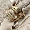 bracelet semainier 7 joncs ouverts en acier doré