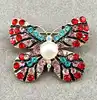 broche broche papillon rouge pavé d'oxydes en métal doré t3 x 4 cm