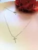 collier messika en or rose avec un pendentif croix serti des petits diamants d'environ 0,17ct au total or 750 millième (18 ct) 2,5