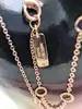 collier messika en or rose avec un pendentif croix serti des petits diamants d'environ 0,17ct au total or 750 millième (18 ct) 2,5