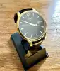 montre tissot t063610a, mouvement quartz, cadran noir, boîtier doré et bracelet en cuir noir