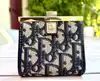 porte-monnaie christian dior vintage en toile oblique avec un fermoir clip doré
