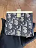 porte-monnaie christian dior vintage en toile oblique avec un fermoir clip doré