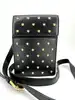 sac bandoulière versace medusa en cuir noir orné de clous métalliques dorés à motif méduse