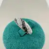 bague entrelacée ornée d'oxydes noirs et blancs t50 argent 925 millième (22 ct) 2,65g
