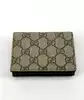 portefeuille gucci bicolore gg marmont en cuir noir et toile beige